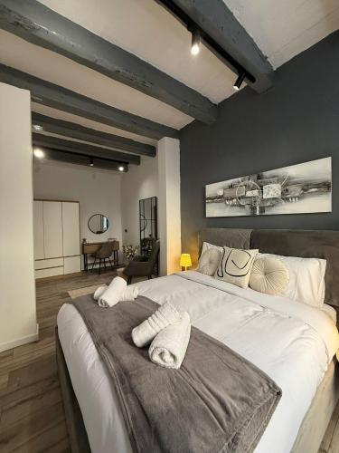 a large bedroom with a large bed with white sheets at Iconic Suites Valletta in Valletta