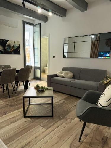 a living room with a couch and a table at Iconic Suites Valletta in Valletta