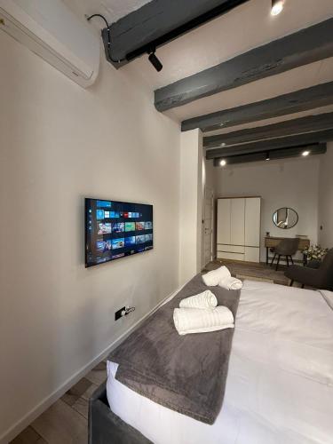 a room with a bed and a tv on the wall at Iconic Suites Valletta in Valletta