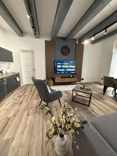 a living room with a couch and a tv at Iconic Suites Valletta in Valletta