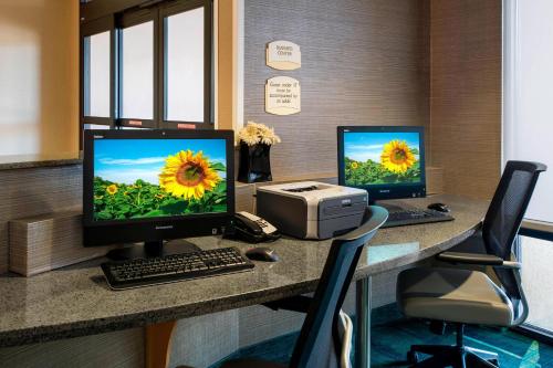 a desk with two computer monitors and a printer at SpringHill Suites by Marriott Omaha East, Council Bluffs, IA in Council Bluffs