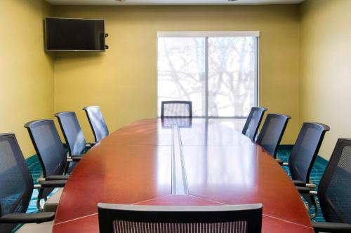 a conference room with a long table and chairs at SpringHill Suites by Marriott Omaha East, Council Bluffs, IA in Council Bluffs