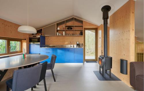 a kitchen with a table and a stove in a room at 3 Bedroom Stunning Home In Spier in Spier
