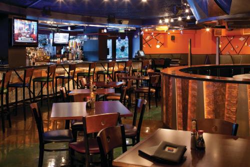 a restaurant with tables and chairs and a bar at Marriott's Timber Lodge in South Lake Tahoe