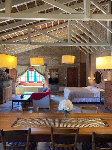 a large room with a bed and a living room at Casitas El Lago in Carhué