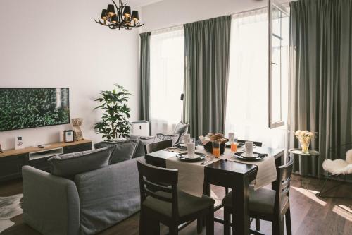 a living room with a table and a couch at "Hunter's Suite"- at the heart of Hartberg I Parking in Hartberg