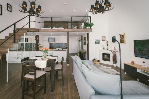 a dining room and living room with a table and chairs at "Hunter's Suite"- at the heart of Hartberg I Parking in Hartberg