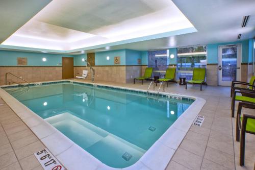 a pool in the lobby of a hotel at SpringHill Suites by Marriott St. Joseph Benton Harbor in Benton Harbor