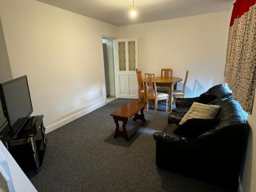 a living room with a couch and a table at Double bed D3 Greater Manchester in Manchester