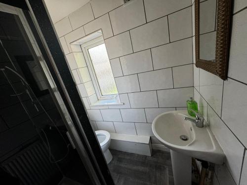 a bathroom with a sink and a toilet at Double bed D3 Greater Manchester in Manchester