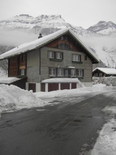 a house with snow on the side of a road at Seeli in Hofstetten 