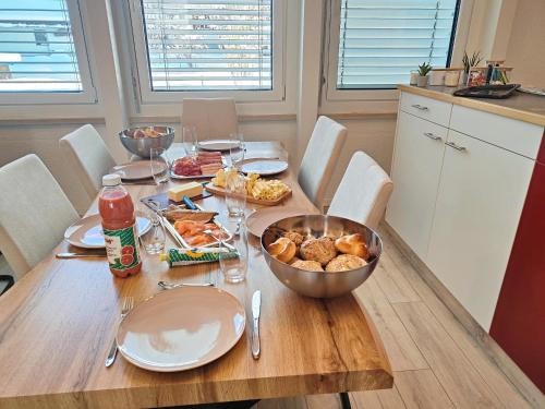a wooden table with a bowl of food on it at ganzes Haus für dich 20min bis nach Interlaken und Adelboden in Frutigen