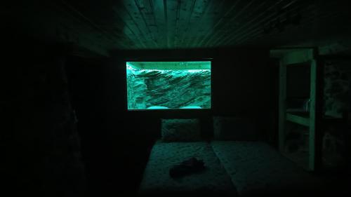 a room with a window in a dark room at Adonis Guest House in Dhimitsana