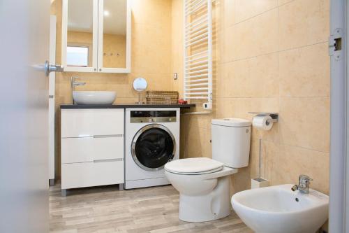a bathroom with a toilet and a sink and a washing machine at Terraza Privada I Refugio Tranquilo con Vistas in Canillo
