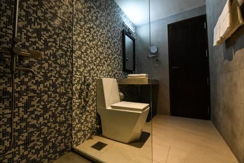 a bathroom with a toilet and a sink at Hiriketiya Beach Resort in Hiriketiya