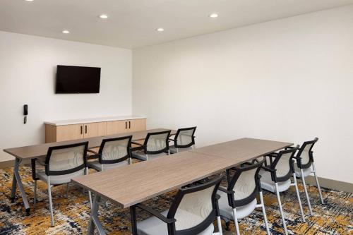 a conference room with tables and chairs and a flat screen tv at TownePlace Suites by Marriott Tampa Casino Area in Tampa