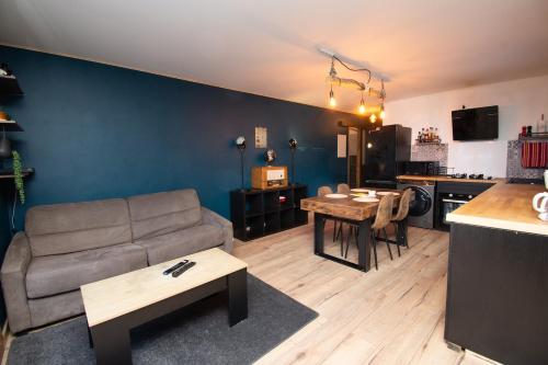 a living room with a couch and a table at L'Atelier des Pistes à Métabief in Métabief