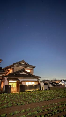 a house at night with a field in front of it at Eastern sunrise home Valuable historical Japanese-style exclusive 4mins to ocean in Choshi