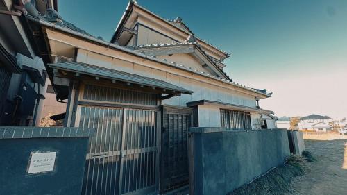 an old house with a gate and a fence at Eastern sunrise home Valuable historical Japanese-style exclusive 4mins to ocean in Choshi