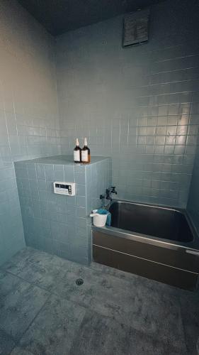 a bathroom with a bath tub and a sink at Eastern sunrise home Valuable historical Japanese-style exclusive 4mins to ocean in Choshi