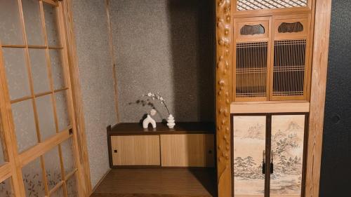 a room with a door and a cat sitting on a table at Eastern sunrise home Valuable historical Japanese-style exclusive 4mins to ocean in Choshi