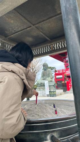 a woman is standing in front of a statue at Eastern sunrise home Valuable historical Japanese-style exclusive 4mins to ocean in Choshi