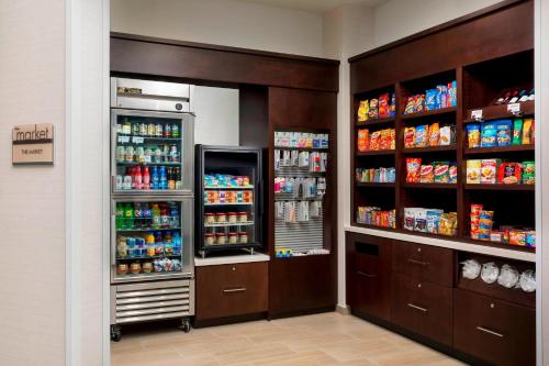 a grocery store aisle with two large refrigerators at SpringHill Suites by Marriott San Diego Mission Valley in San Diego