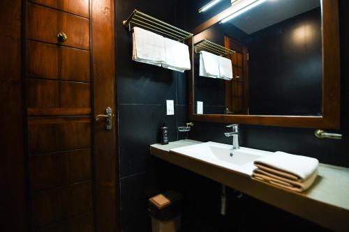 a bathroom with a sink and a mirror at Hiriketiya Beach Resort in Hiriketiya