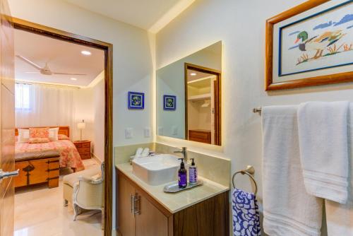 a bathroom with a sink and a mirror and a bed at El Tigre Resort, Quinta San Miguel in Nuevo Vallarta 