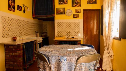 eine Küche mit einem Tisch und einer Theke mit einem Tisch und Stühlen in der Unterkunft Case Troccoli in Caltabellotta