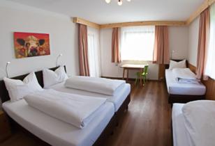 a large room with two beds and a couch at Gästehaus Zum Steirischen Kuss in Aich