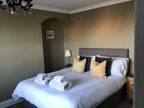 a bedroom with a bed with towels on it at Greystones guesthouse in Whitby