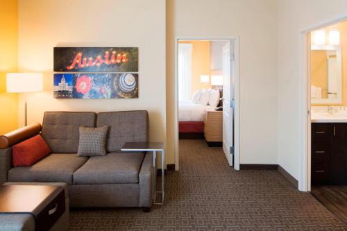 a hotel room with a couch and a bed at TownePlace Suites by Marriott Austin Round Rock in Round Rock