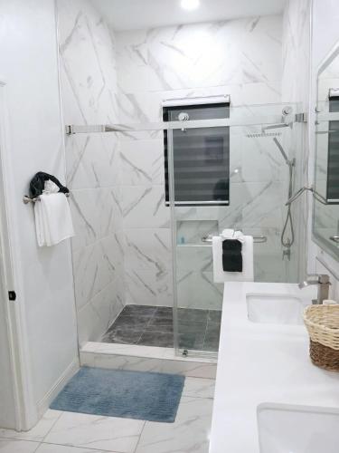 a bathroom with a shower with a glass door at Blanco Oasis in Banks