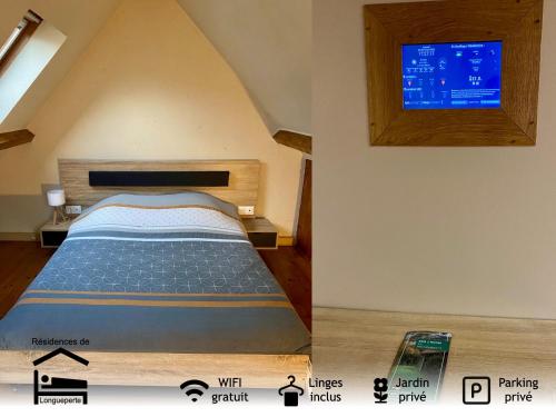 une chambre avec un lit et une télévision au mur dans l'établissement La maisonnette, à Saint-Hilaire-sous-Romilly