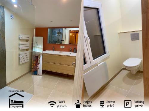 un bagno con lavandino, WC e finestra di La maisonnette a Saint-Hilaire-sous-Romilly