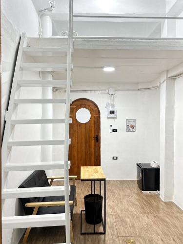 a loft bed in a room with a staircase at Megun 10 Duplex in Bangkok