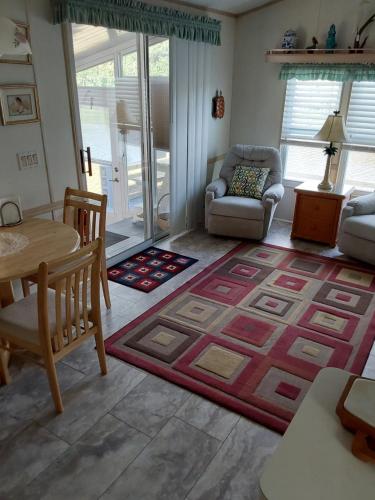 a living room with a table and a rug at holiday dream house in Port Charlotte