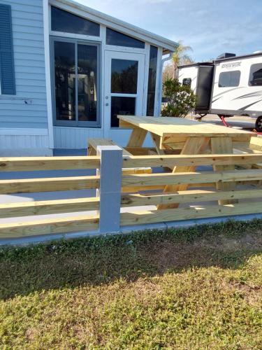 a wooden deck with a picnic table in front of a house at holiday dream house in Port Charlotte