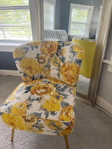 a yellow and white chair in a room at Huffman House Bed & Breakfast in Minden