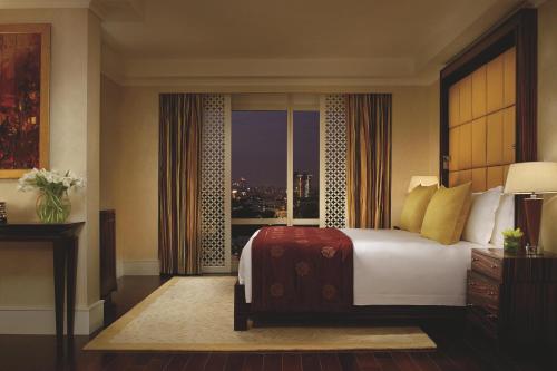 a bedroom with a bed and a window with a view at The Ritz-Carlton, Bangalore in Bengaluru