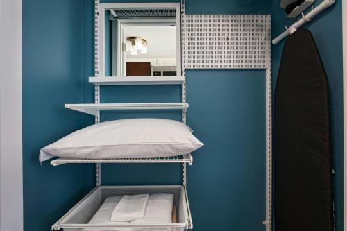 a room with a shelf with a pillow and a mirror at TownePlace Suites by Marriott Macon Mercer University in Macon