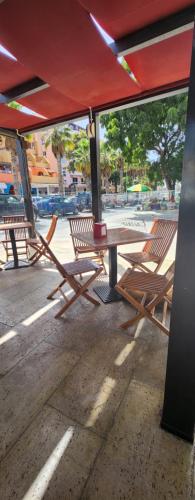 a picnic table and chairs sitting under a tent at MEETING POINT HOSTEL-Praia Group Reservations in Praia