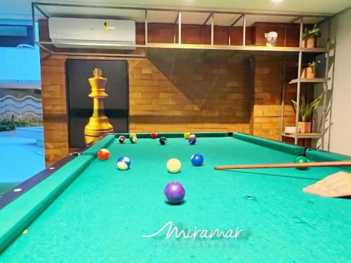 a pool table with billiard balls in a room at Blue Beach Residence in Cabedelo