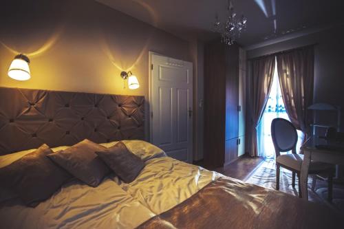 a bedroom with a bed and a desk and a window at Luxury-Villas in Sopron