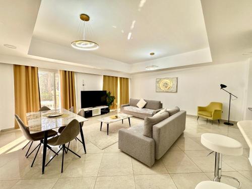 a living room with a couch and a table at Perfect Home Away from Home 3 BR - Maids in Ras al Khaimah