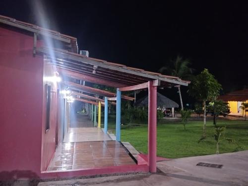 a night view of a building with a lit up walkway at Chalé Rota Das Dunas in Barreirinhas