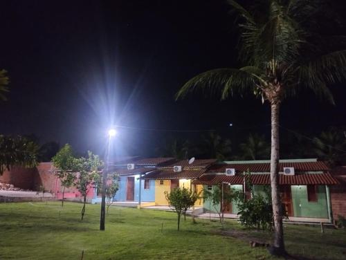 a street light in front of houses at night at Chalé Rota Das Dunas in Barreirinhas