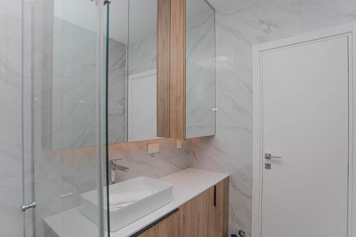 a bathroom with a sink and a mirror at Luxury Apartment Providenca with Private Rooftop Terrace in Podstrana