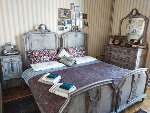a bedroom with a bed with towels on it at L'angolo in Turin
